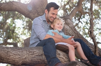 Man with small child in tree